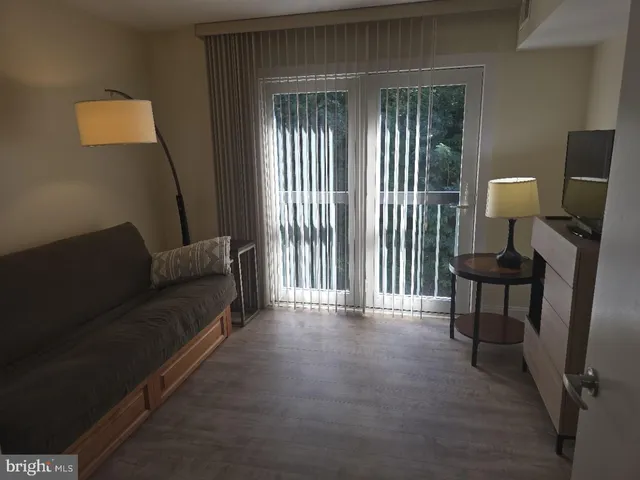 a living room with furniture and a lamp