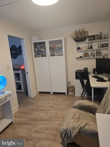 a view of a workspace with furniture and cabinets