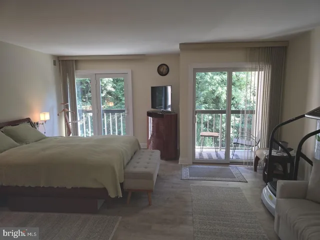 a bedroom with a bed and a night stand