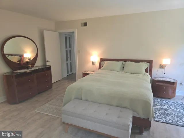 a bedroom with a bed and a mirror