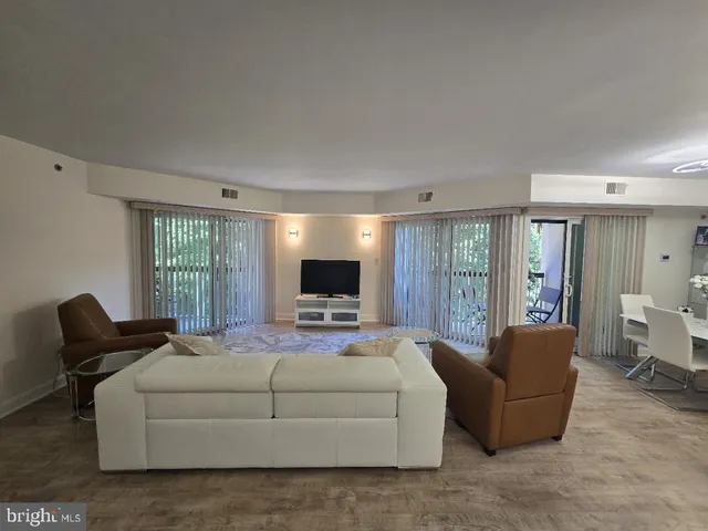 a bedroom with a bed and large window