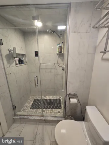 a bathroom with a toilet and a shower