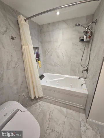 a bathroom with a toilet a sink and a mirror