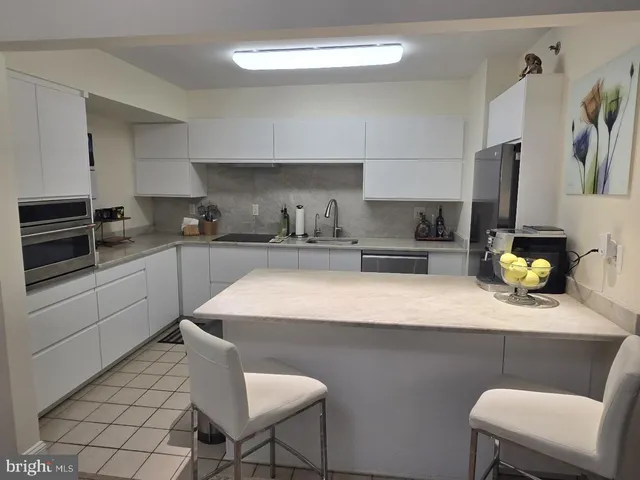 a kitchen with a sink cabinets and appliances