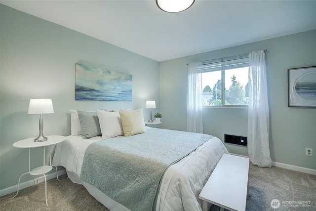 a bedroom with a bed and a lamp