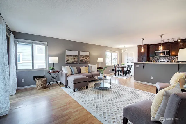a living room with furniture and a wooden floor