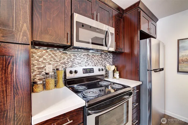 a kitchen with a stove and a microwave