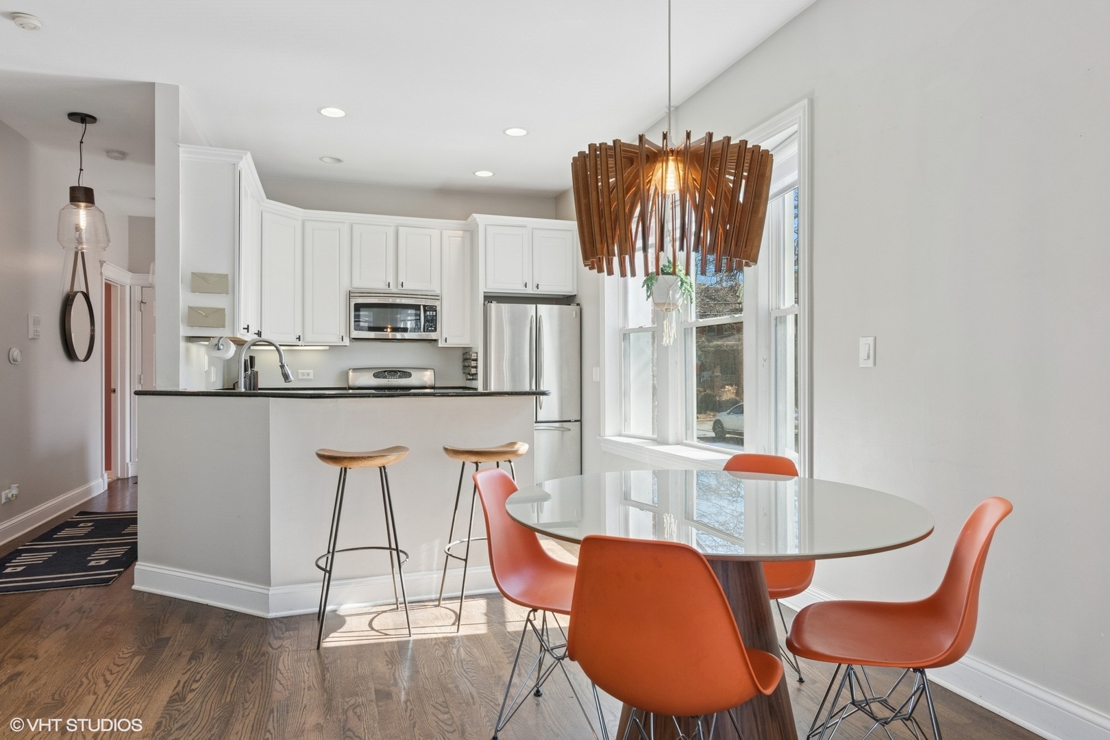1650 West Rascher Avenue, Unit 1W Chicago, IL 60640 - Photo 3 of 19 a dining room filled chandelier and wooden floor