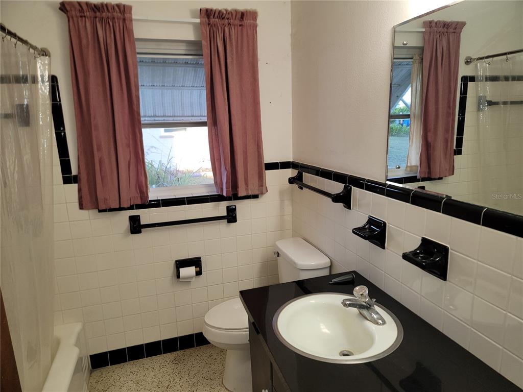 259 Gardenia Road Venice, FL 34293 - Photo 6 of 6 a bathroom with a sink mirror and toilet