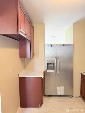 a kitchen with stainless steel appliances granite countertop a refrigerator a stove and a microwave