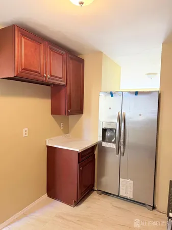 a kitchen with stainless steel appliances a refrigerator and cabinets