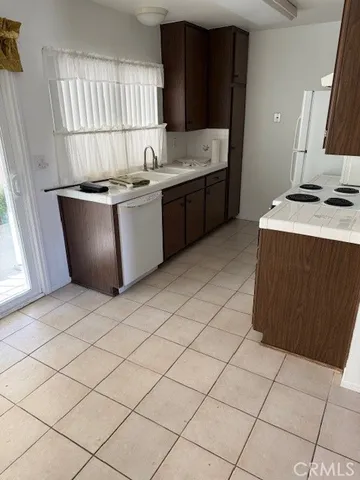 a kitchen with stainless steel appliances granite countertop a sink and a stove
