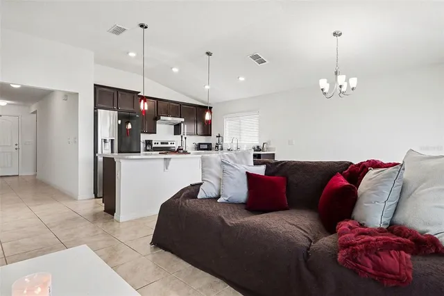a living room with furniture and kitchen view