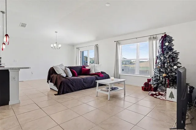 a living room with furniture and a christmas tree