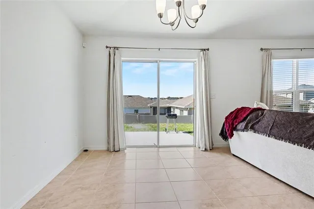 a bedroom with a balcony a bed and a window