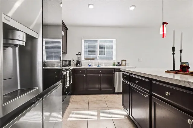 a kitchen with a sink and stainless steel appliances