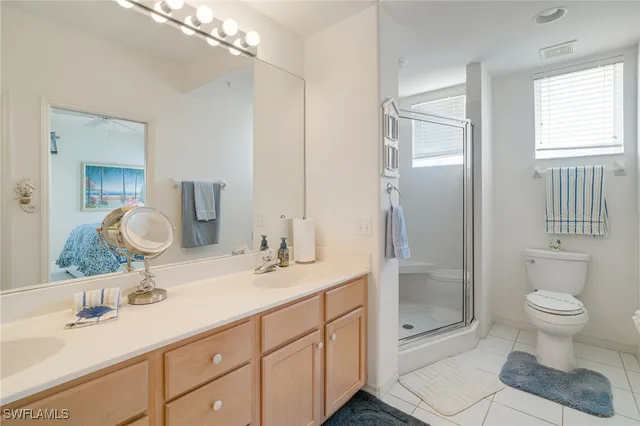 a bathroom with a double vanity sink toilet and shower