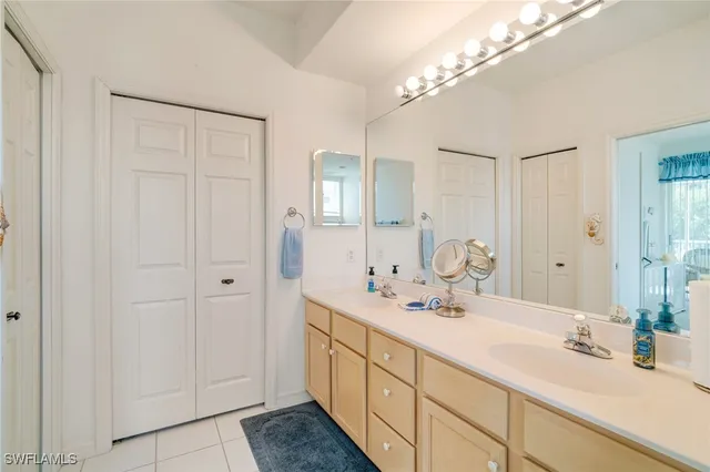a bathroom with a double vanity sink and a mirror