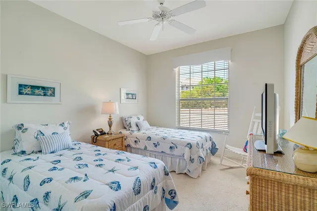 a bedroom with two beds and a window