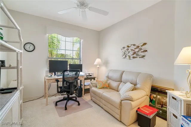 a living room with furniture a clock and a window