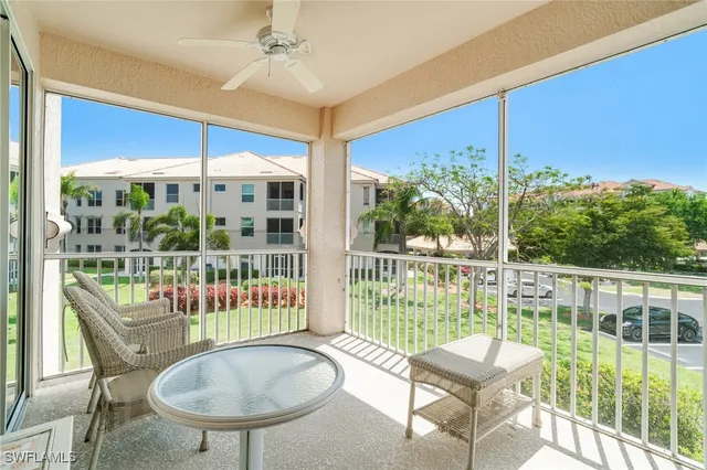 a balcony with furniture and a yard