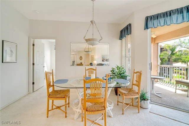 a dining room filled with furniture and a chandelier