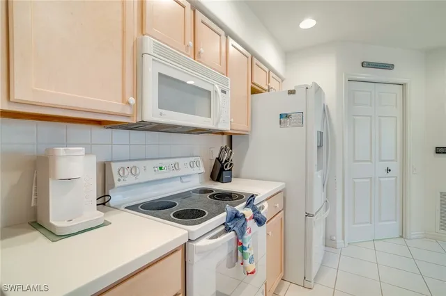 a kitchen with a stove and a refrigerator