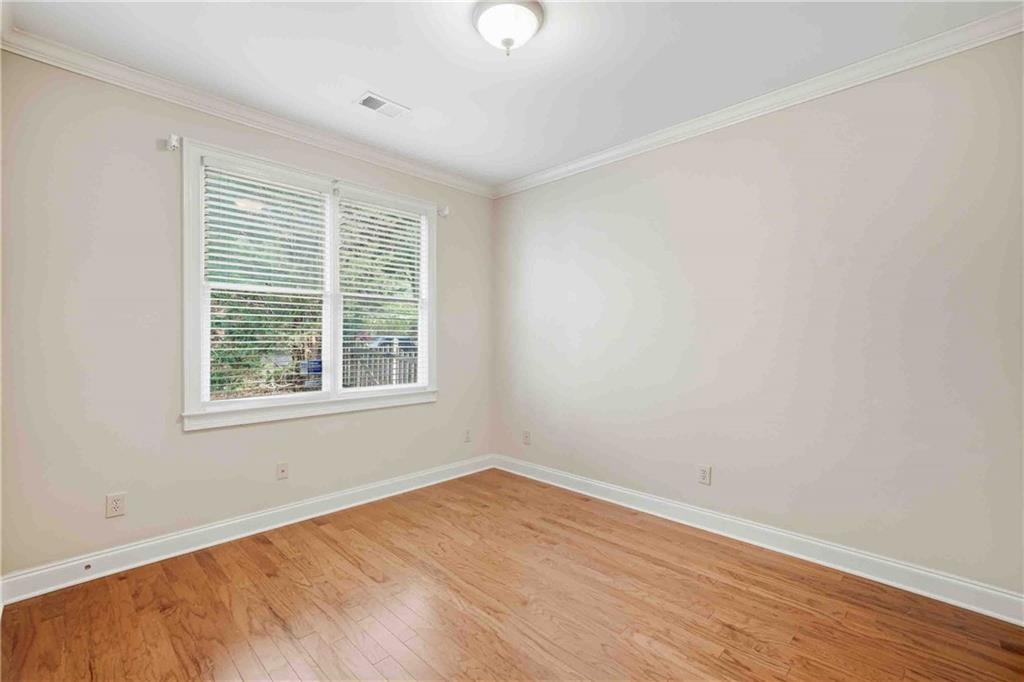 4055 Hill House Road Southwest Smyrna, GA 30082 - Photo 18 of 50 a view of an empty room with wooden floor and a window