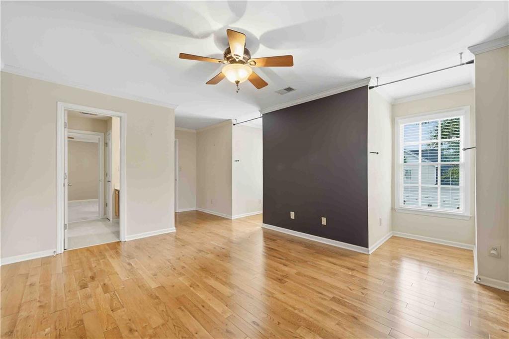 4055 Hill House Road Southwest Smyrna, GA 30082 - Photo 33 of 50 a view of an empty room with wooden floor and a ceiling fan