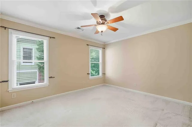 an empty room with closet and fan