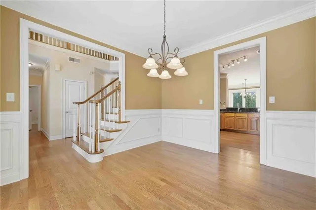 a view of a livingroom with wooden floor and stairs