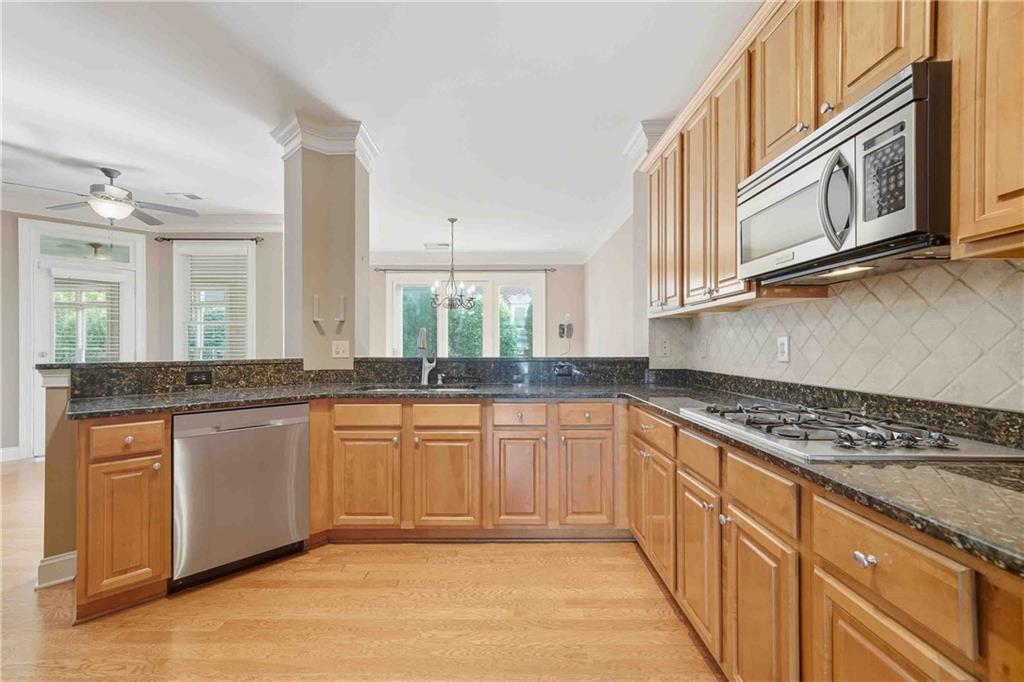 4055 Hill House Road Southwest Smyrna, GA 30082 - Photo 7 of 50 a kitchen with stainless steel appliances granite countertop a stove sink and cabinets