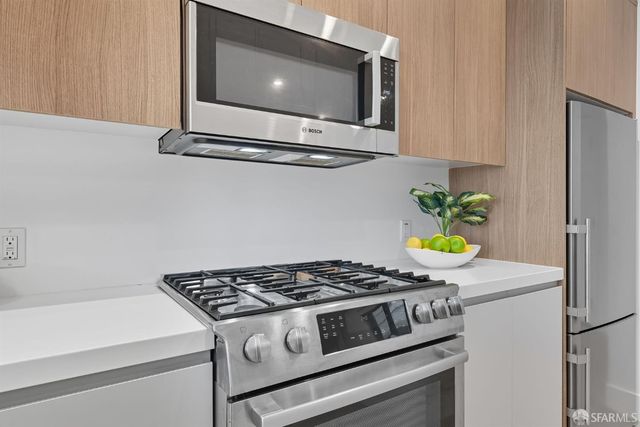 a stove top oven sitting inside of a kitchen