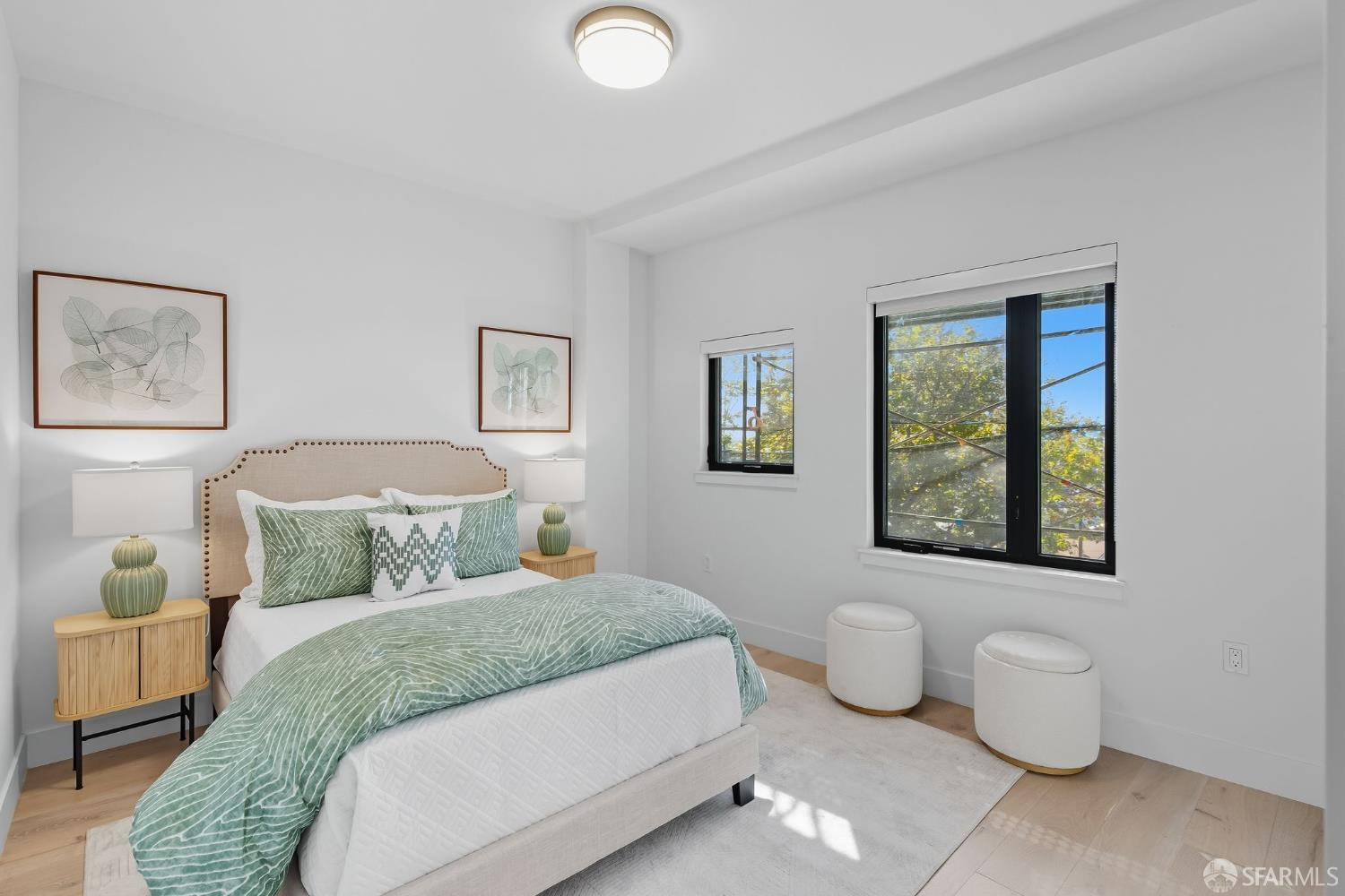 2747 San Pablo Avenue, Unit 406 Berkeley, CA 94702 - Photo 16 of 34 a bedroom with a bed and a painting on the wall