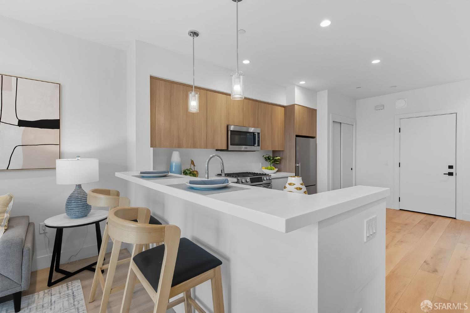 2747 San Pablo Avenue, Unit 406 Berkeley, CA 94702 - Photo 20 of 34 a kitchen with a dining table chairs refrigerator and cabinets