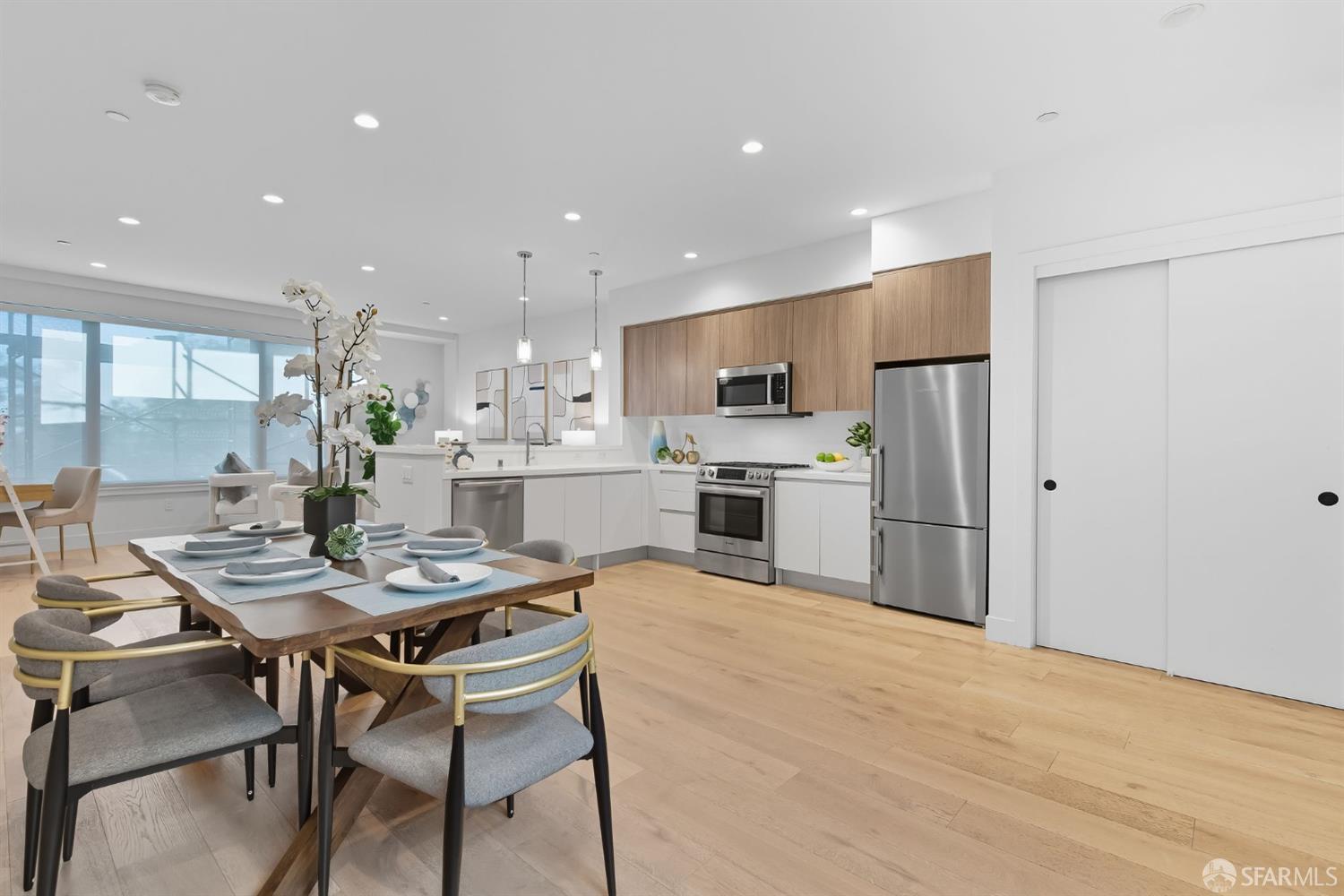 2747 San Pablo Avenue, Unit 406 Berkeley, CA 94702 - Photo 22 of 34 a kitchen with a table chairs refrigerator and wooden floor