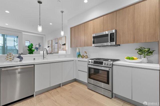 a kitchen with sink cabinets and stainless steel appliances