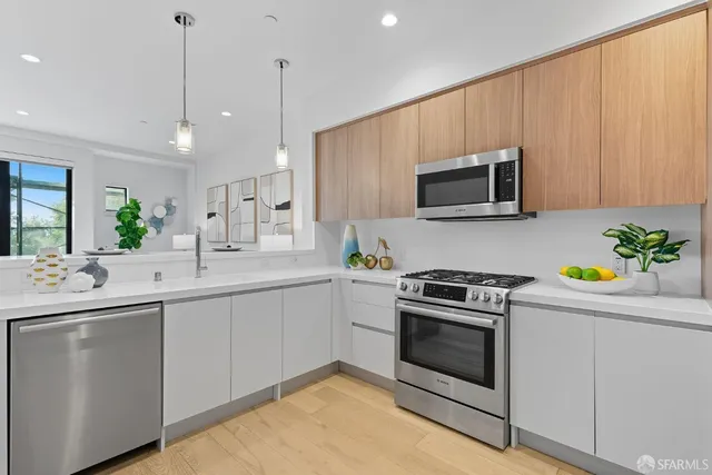 a kitchen with a sink stove and microwave