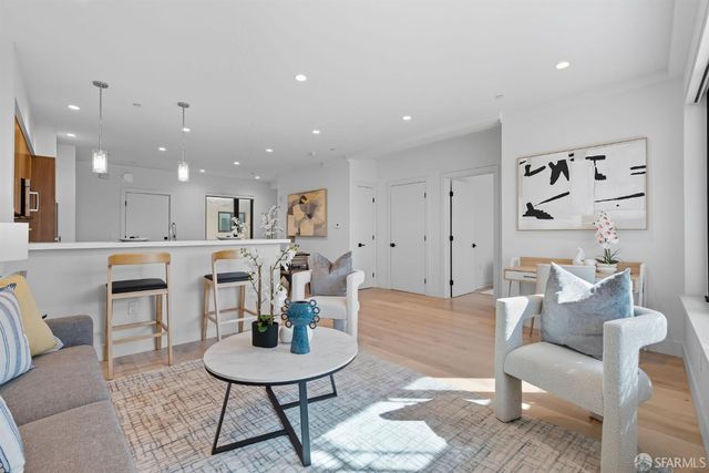 a living room with furniture a dining table and a dining table with kitchen view