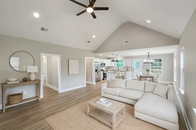 a living room with furniture and a wooden floor