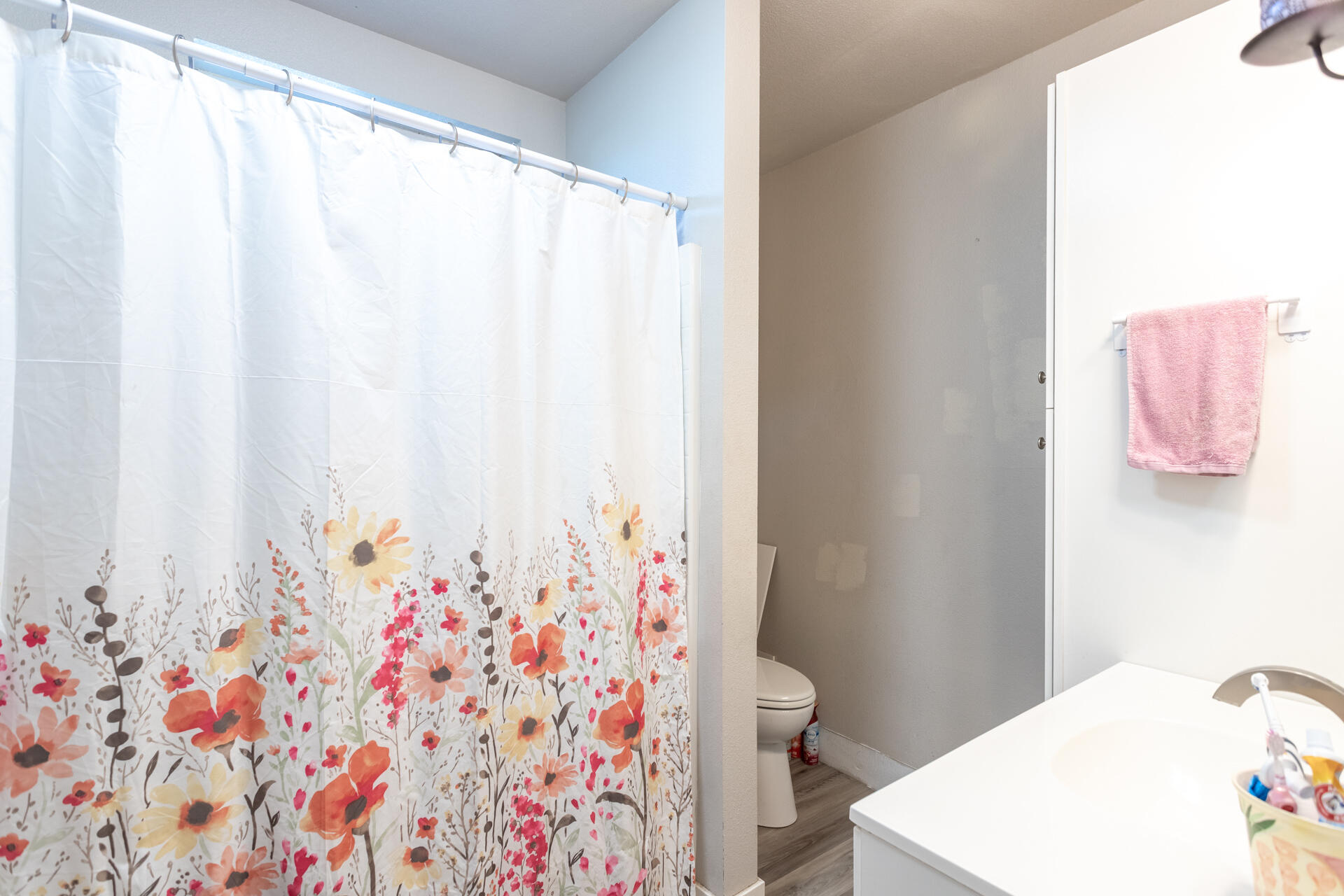 1012 State Street Redding, CA 96001 - Photo 14 of 27 a bathroom with a sink toilet and shower curtain