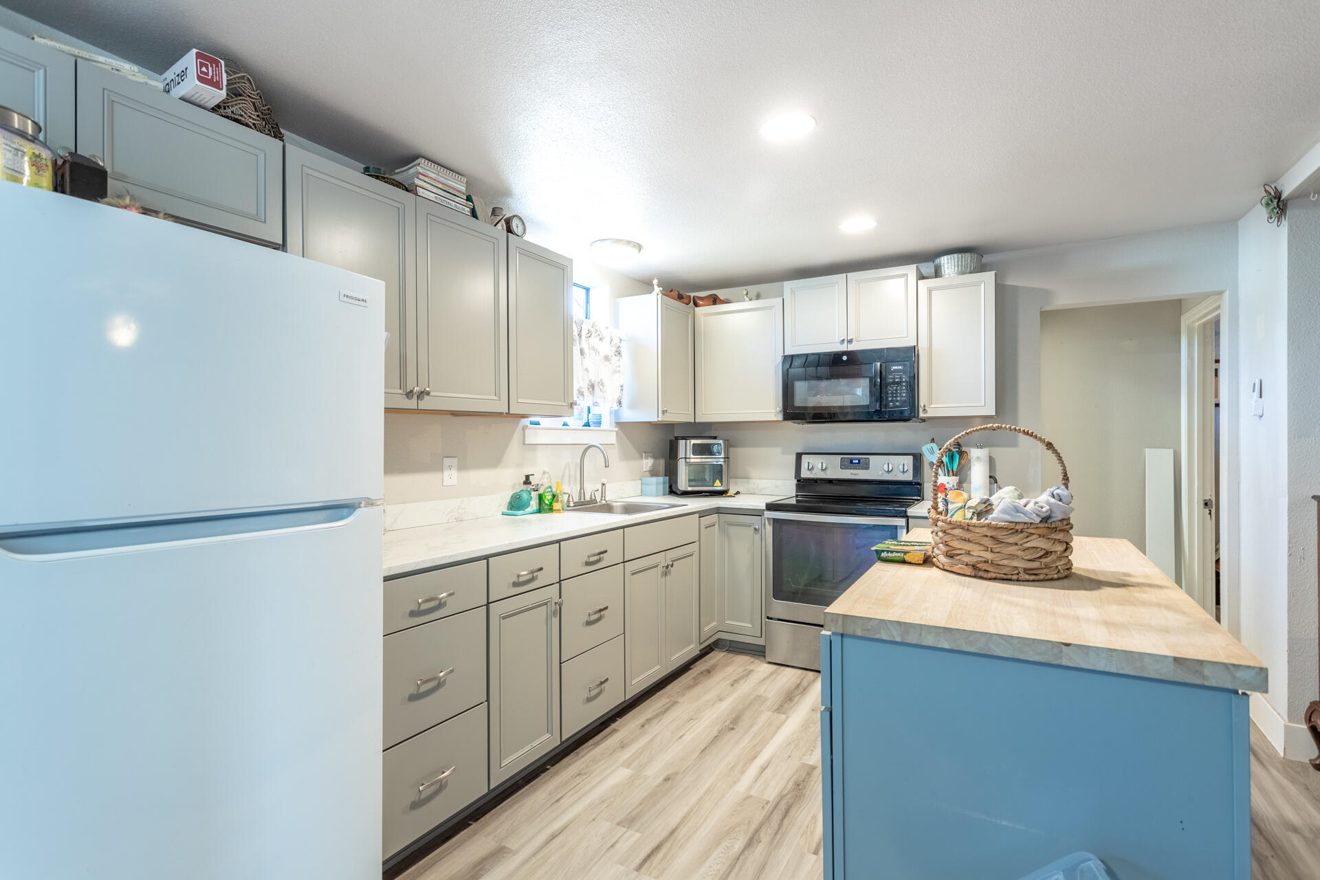 1012 State Street Redding, CA 96001 - Photo 17 of 27 a kitchen with sink refrigerator and microwave
