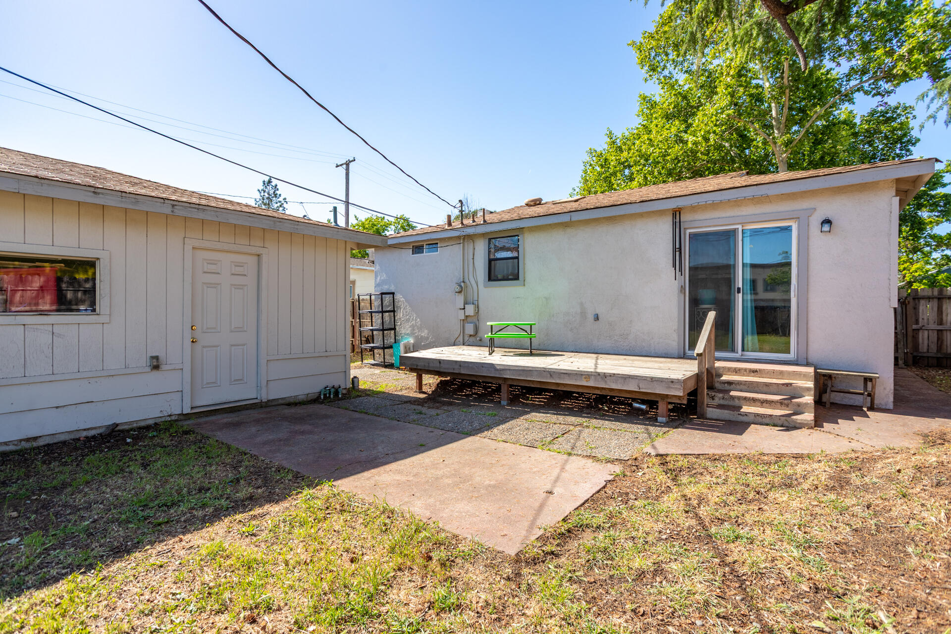 1012 State Street Redding, CA 96001 - Photo 23 of 27 a backyard of a house with barbeque oven table and chairs
