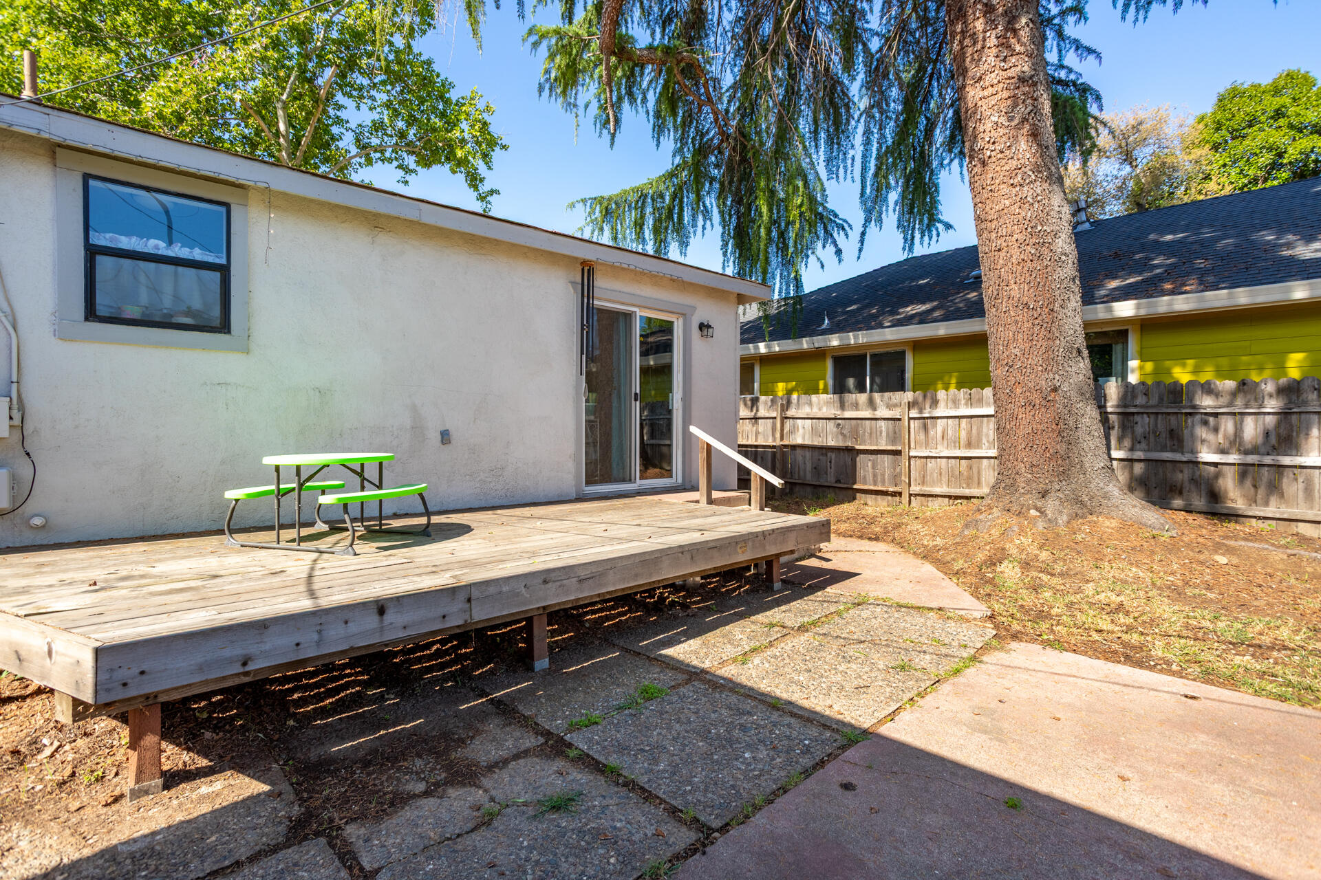 1012 State Street Redding, CA 96001 - Photo 6 of 27 a view of a backyard with a patio and wooden fence