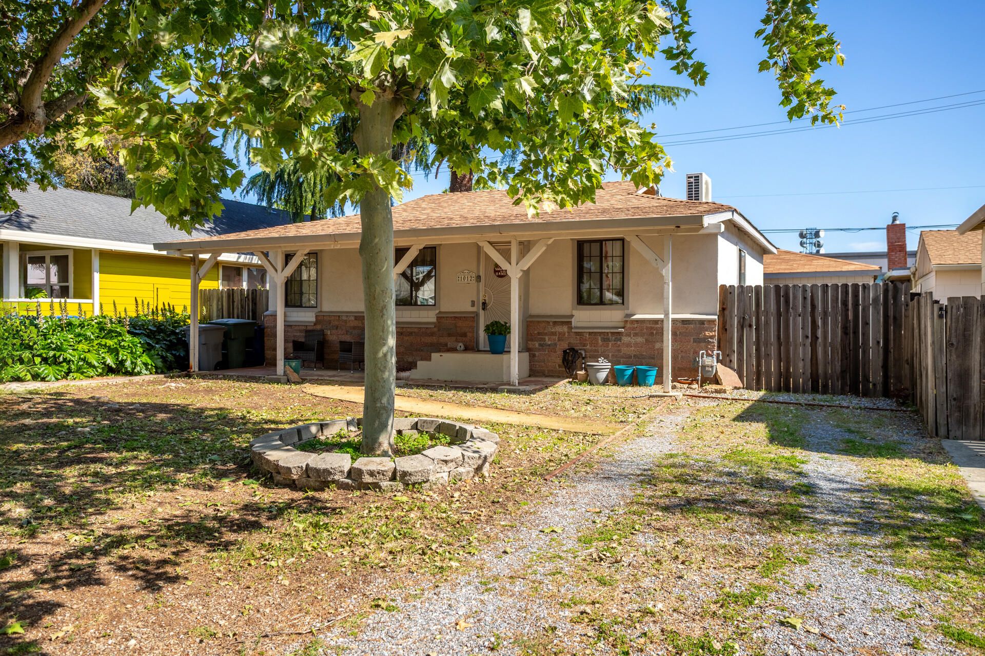 1012 State Street Redding, CA 96001 - Photo 9 of 27 a front view of a house with a yard and potted plants