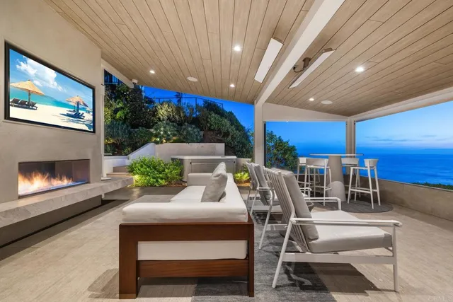 a living room with patio furniture and a fireplace