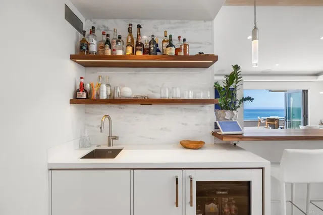 a kitchen with a sink and wooden floor