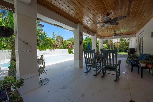 a view of a porch with chairs and backyard
