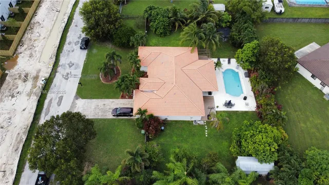 an aerial view of a house with a yard and garden