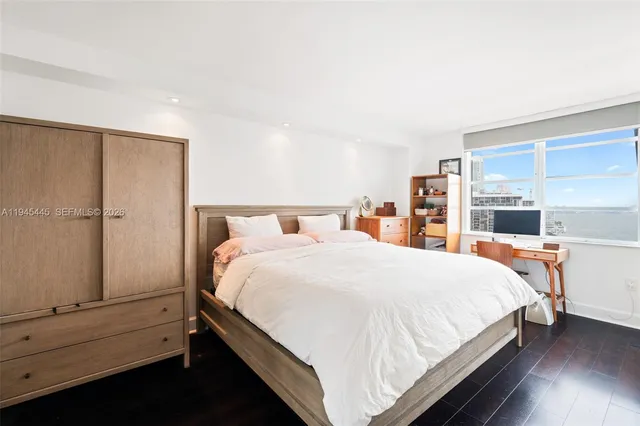 a large bed sitting in a bedroom next to a window